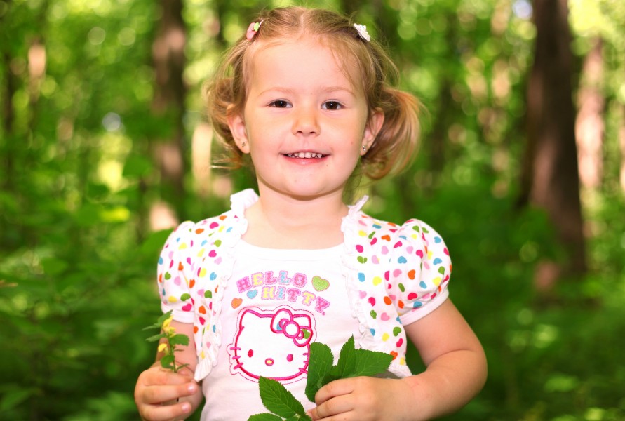 a young cute Catholic girl in a forest in May 2013
