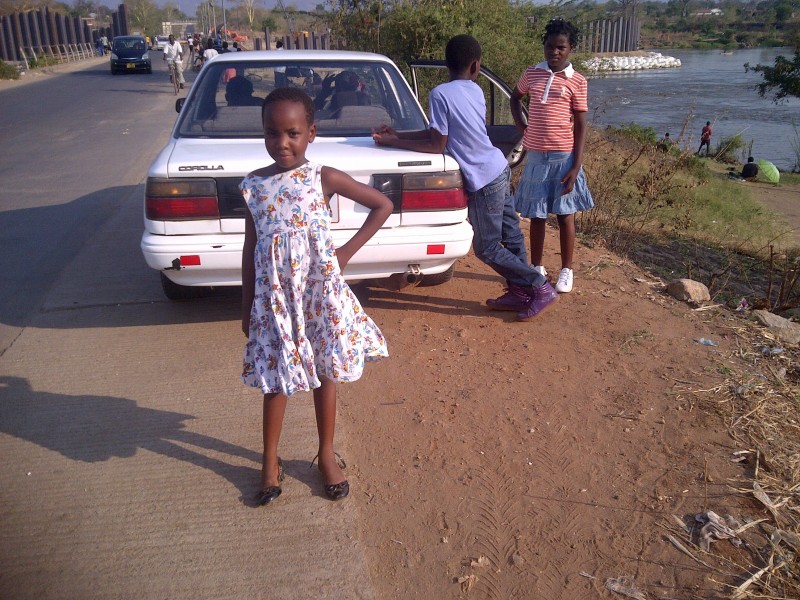 A young girl possing by a barage