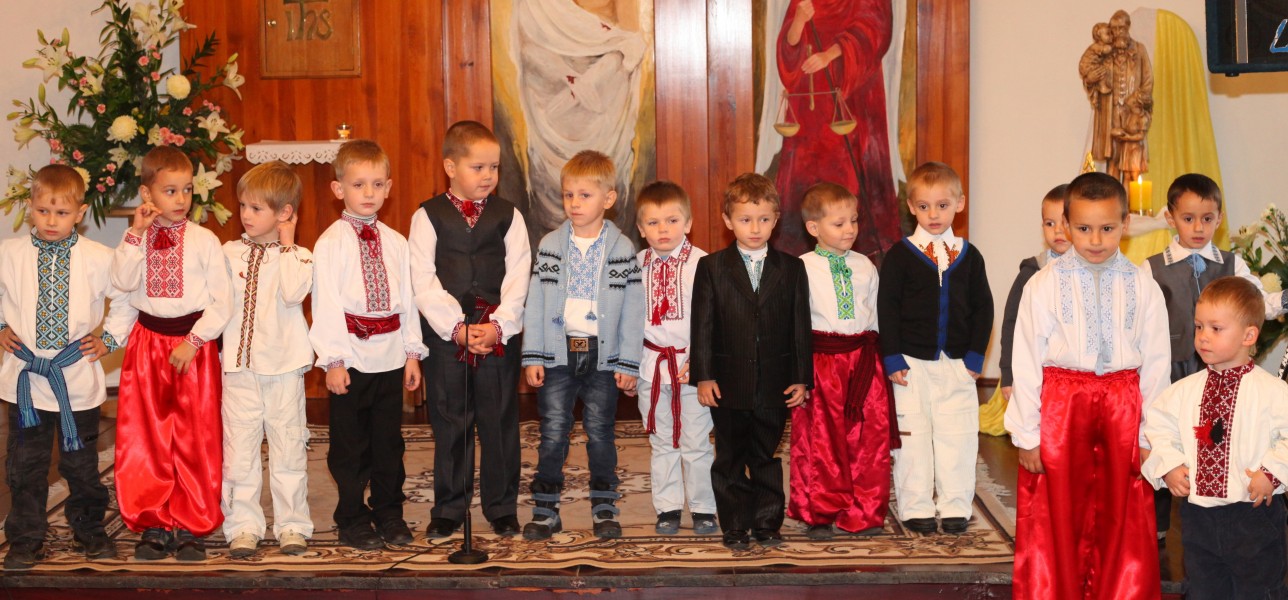 fourteen child boys performing in a Catholic kindergarten