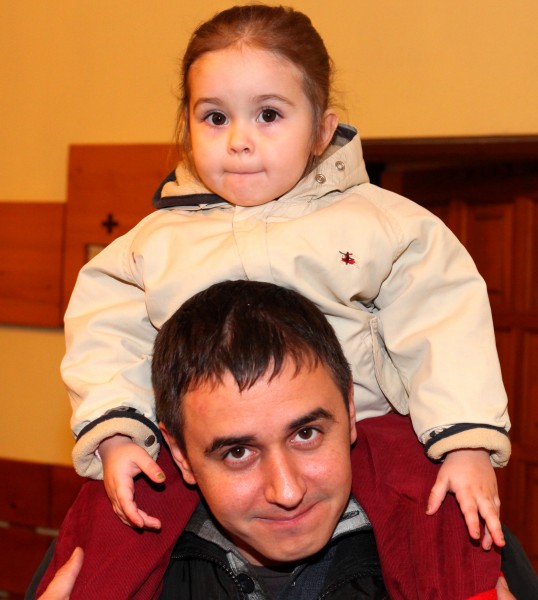a Catholic father with his baby daughter at st. Nicholas day celebration in a Catholic kindergarten, picture 19