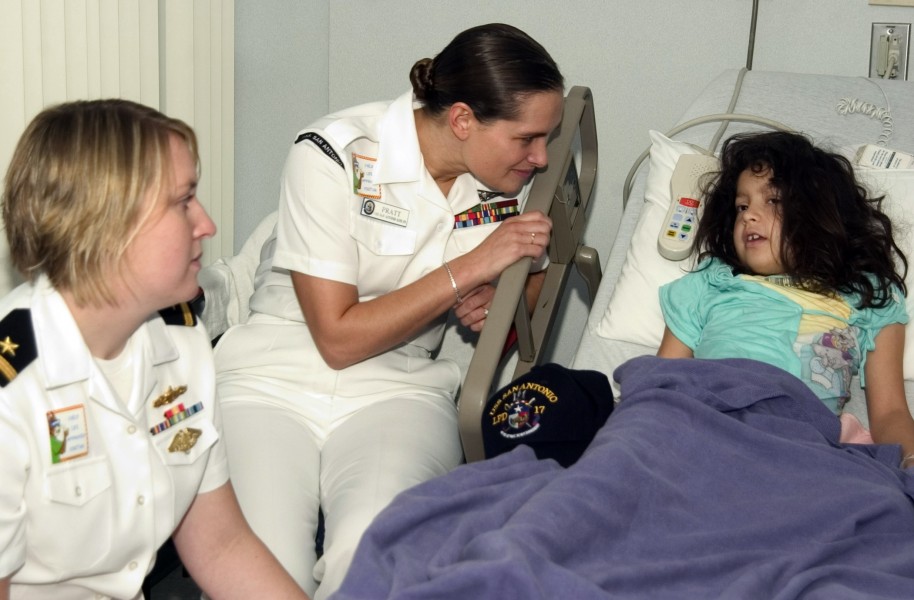 US Navy 061108-N-3750S-147 Six year-old girl talks about what she likes to do at home with Hospital Corpsman 2nd Class April Pratt and Ensign Ann Luken at the Methodist Children's Hospital