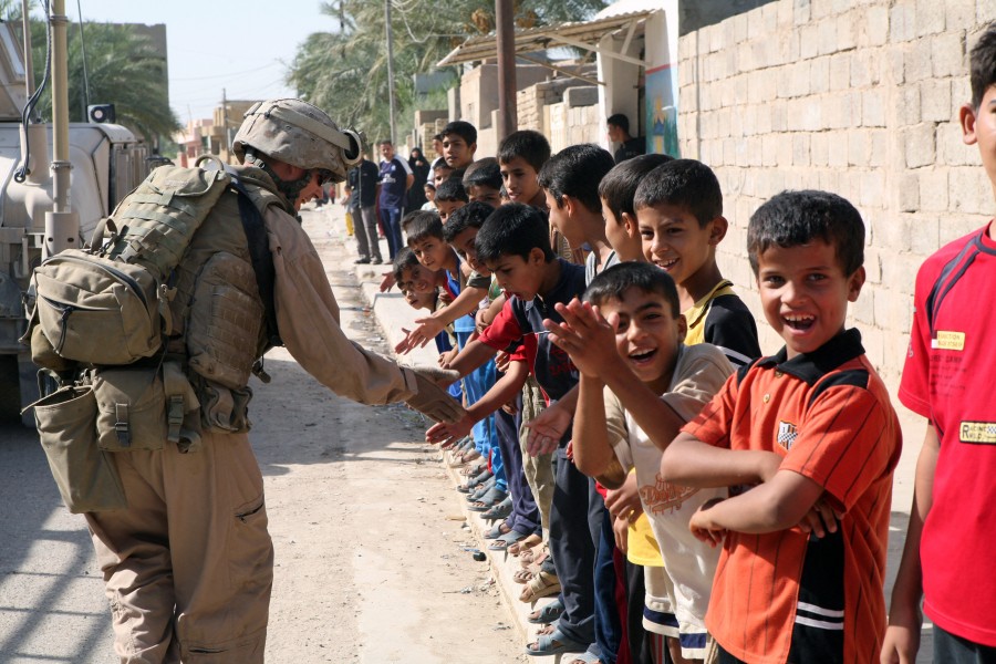 US Navy 070809-M-6412C-028 A Marine attached to Regimental Combat Team (RCT) 6 gives a line of Iraqi children high fives during Operation Alljah