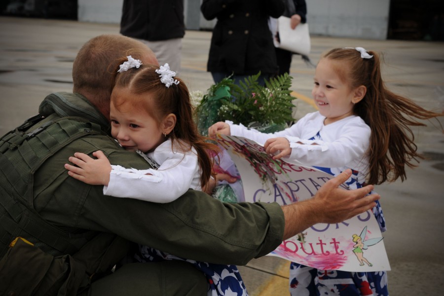 US Navy 100317-N-8590G-004 Lt. Peter Bras reunites with his daughters during a homecoming celebration