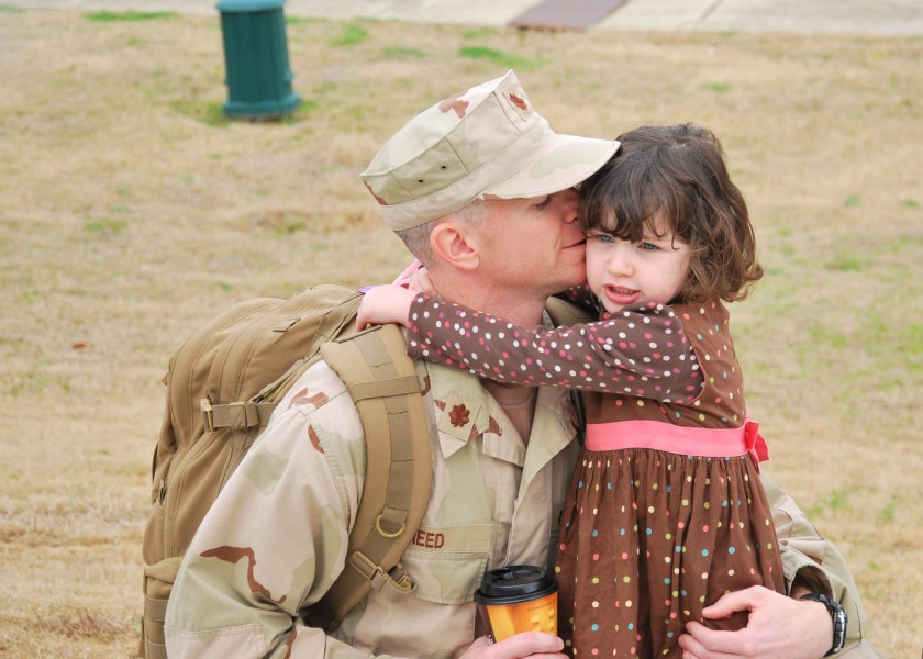 US Navy 110131-N-3285S-007 Lt. Cmdr. Matthew Reed says goodbye to his daughter at the Training Hall at the Naval Construction Battalion Center befo