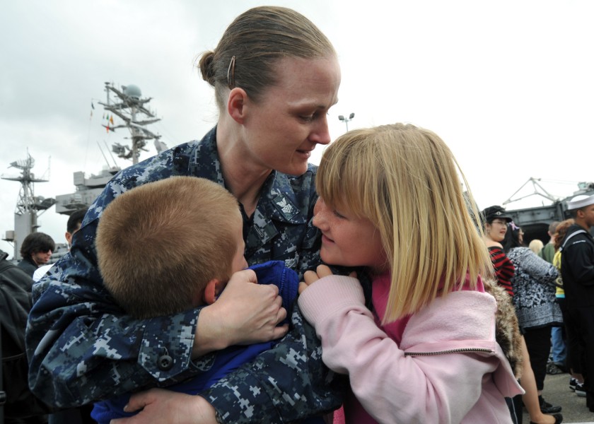 US Navy 110319-N-YB753-170 Mass Communication Specialist 1st Class Sarah Murphy embraces her children upon return from a deployment aboard the airc
