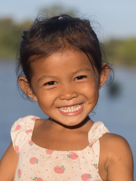 Young girl smiling with teeth in sunshine