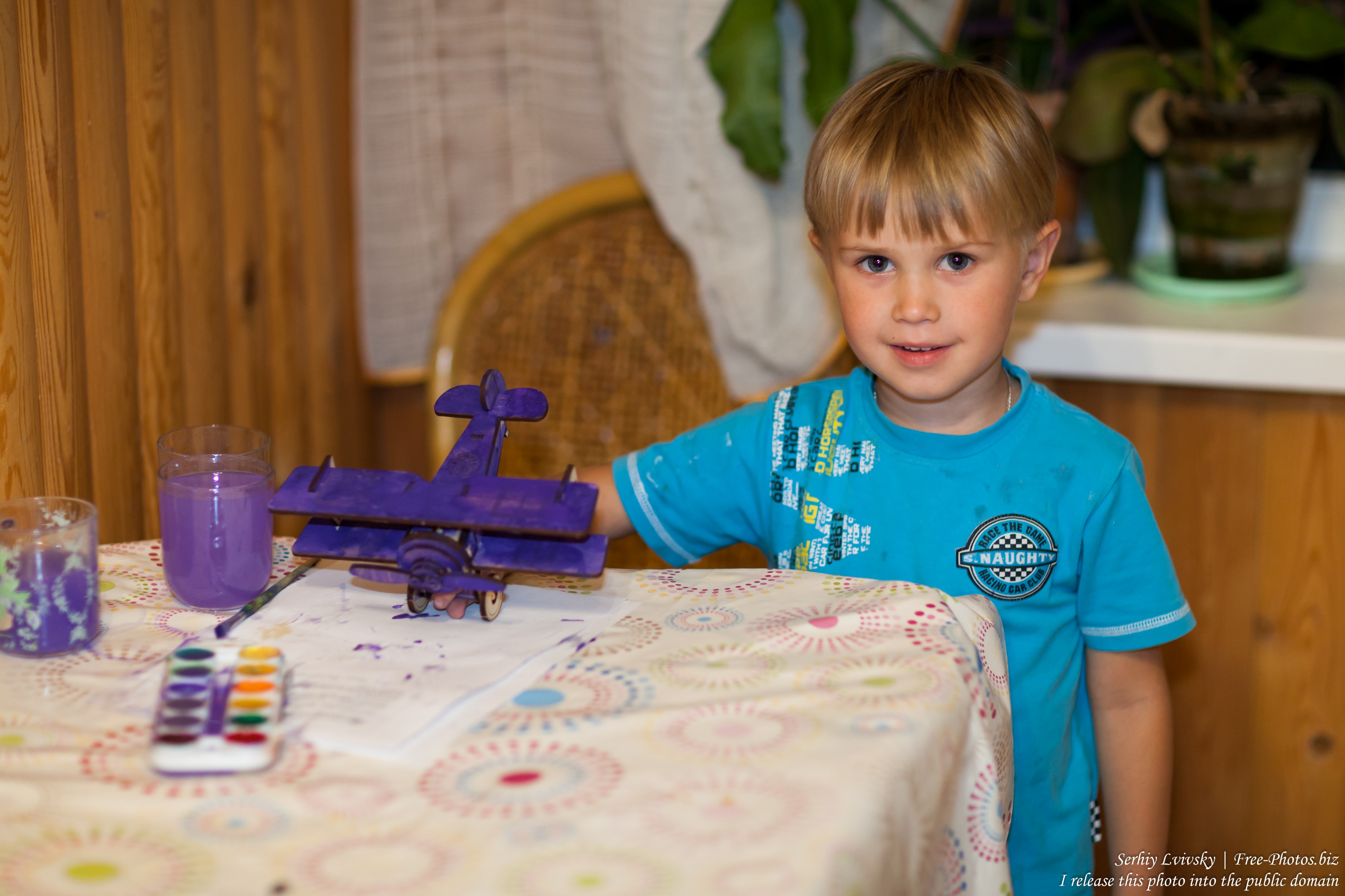 a 4-year-old boy with his newly-painted airplane in August 2017