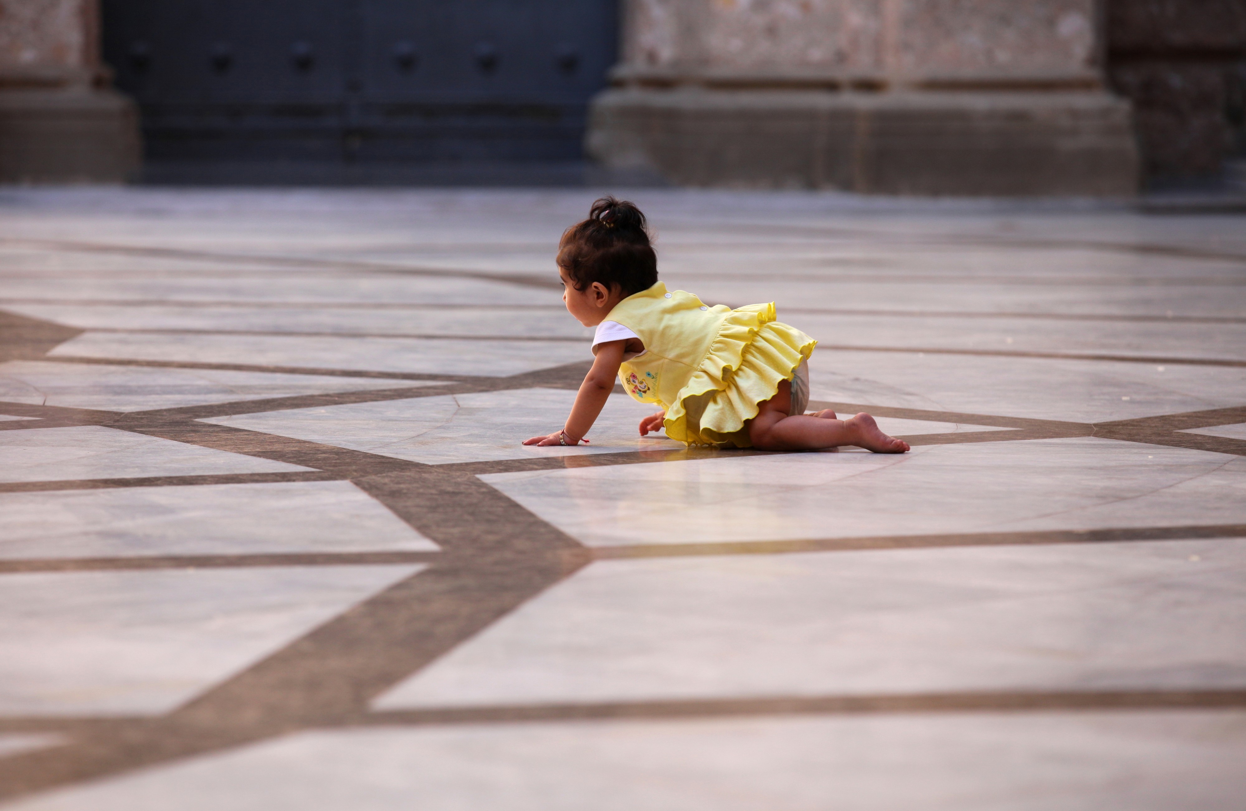 a baby girl crawling in Montserrat sanctuary, Catalonia, Spain, August 2013, photo 1
