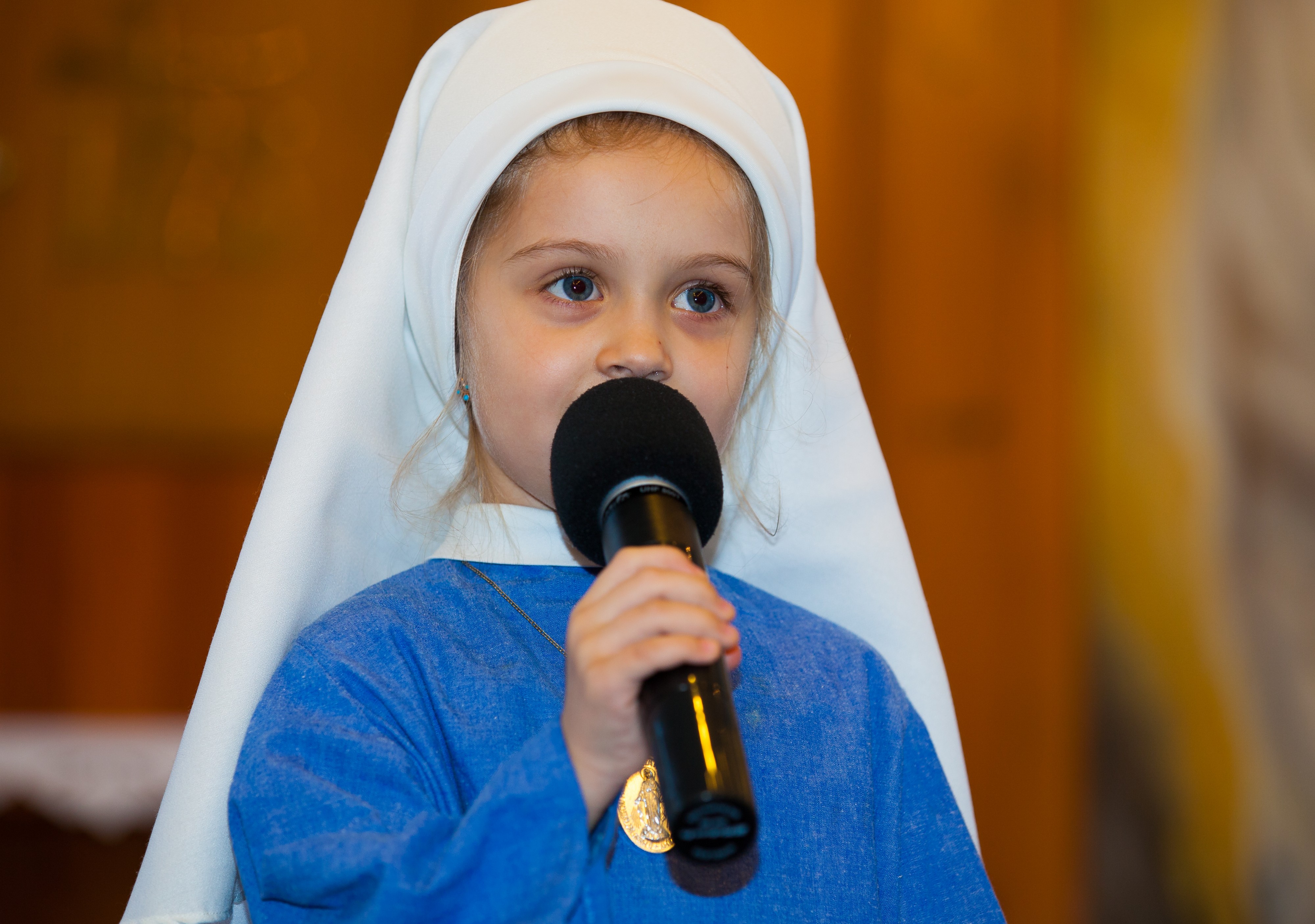 a child girl playing a role of a nun in a Catholic kindergarten in November 2013