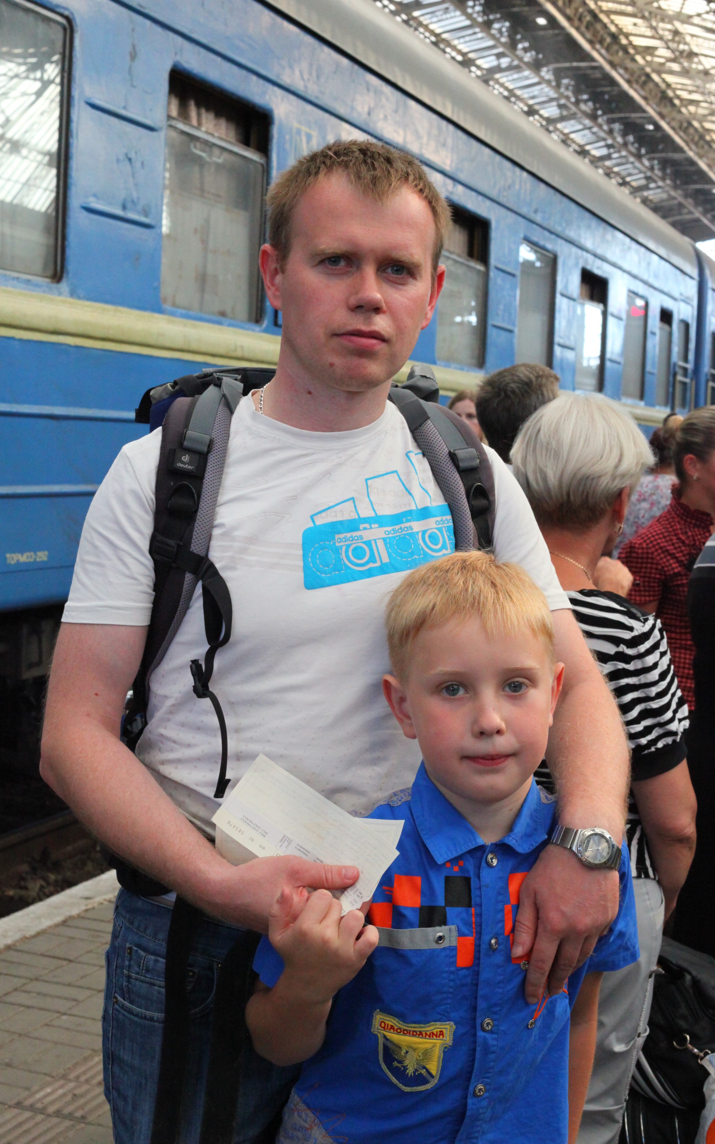 A father and son at a train station