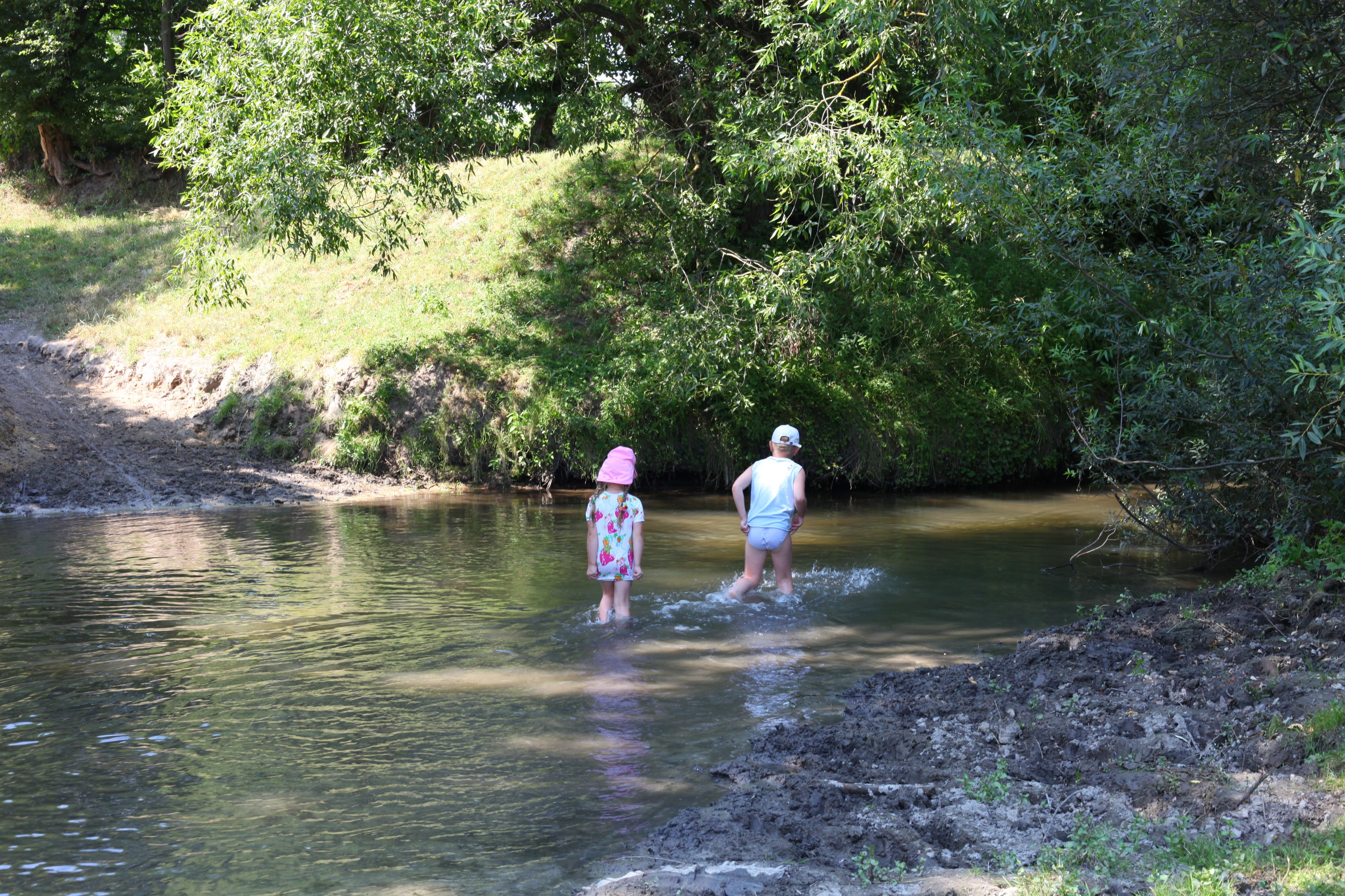Children walking in a river