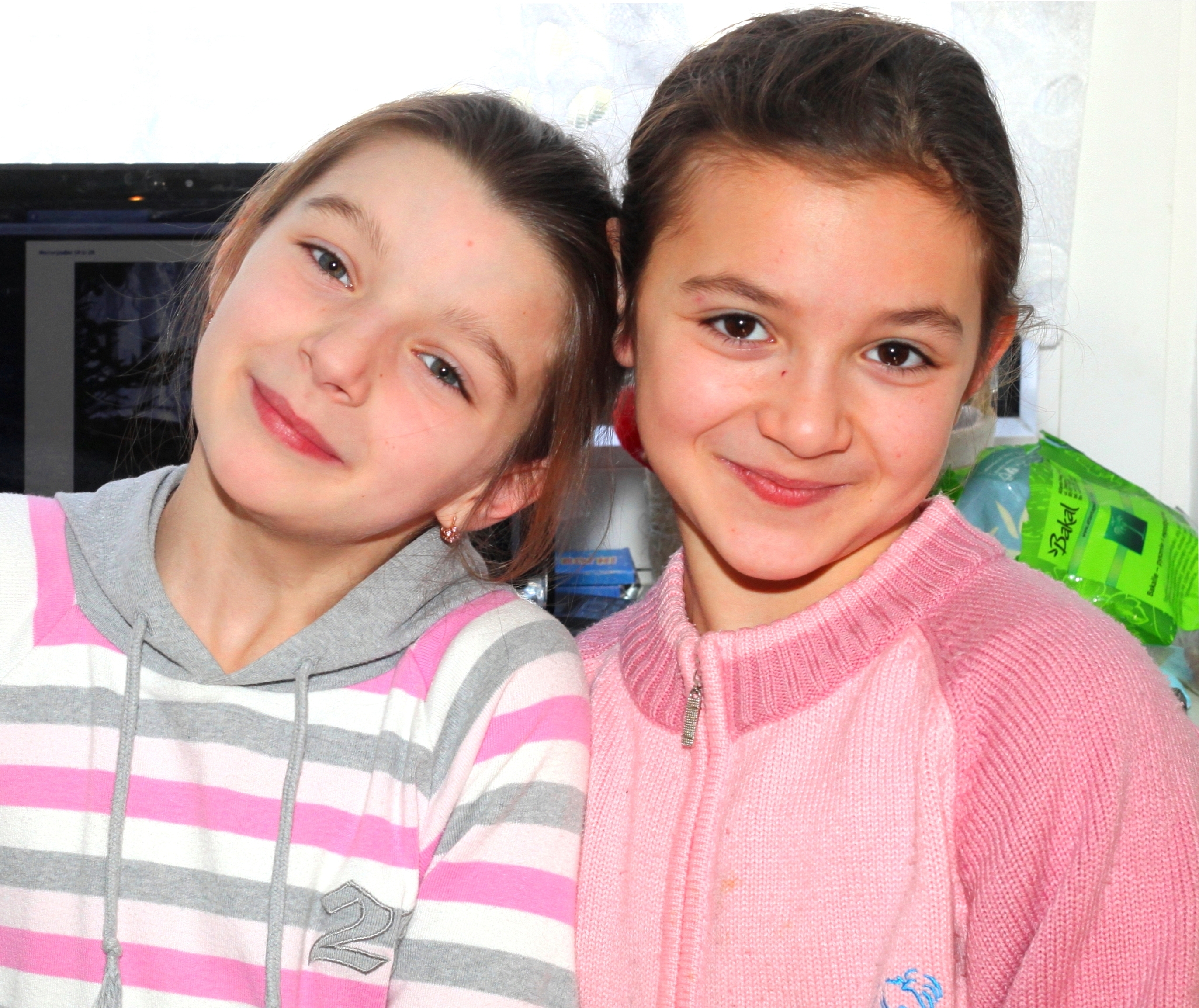 two cute brunette Catholic child girls in the Church's premises, photo 2