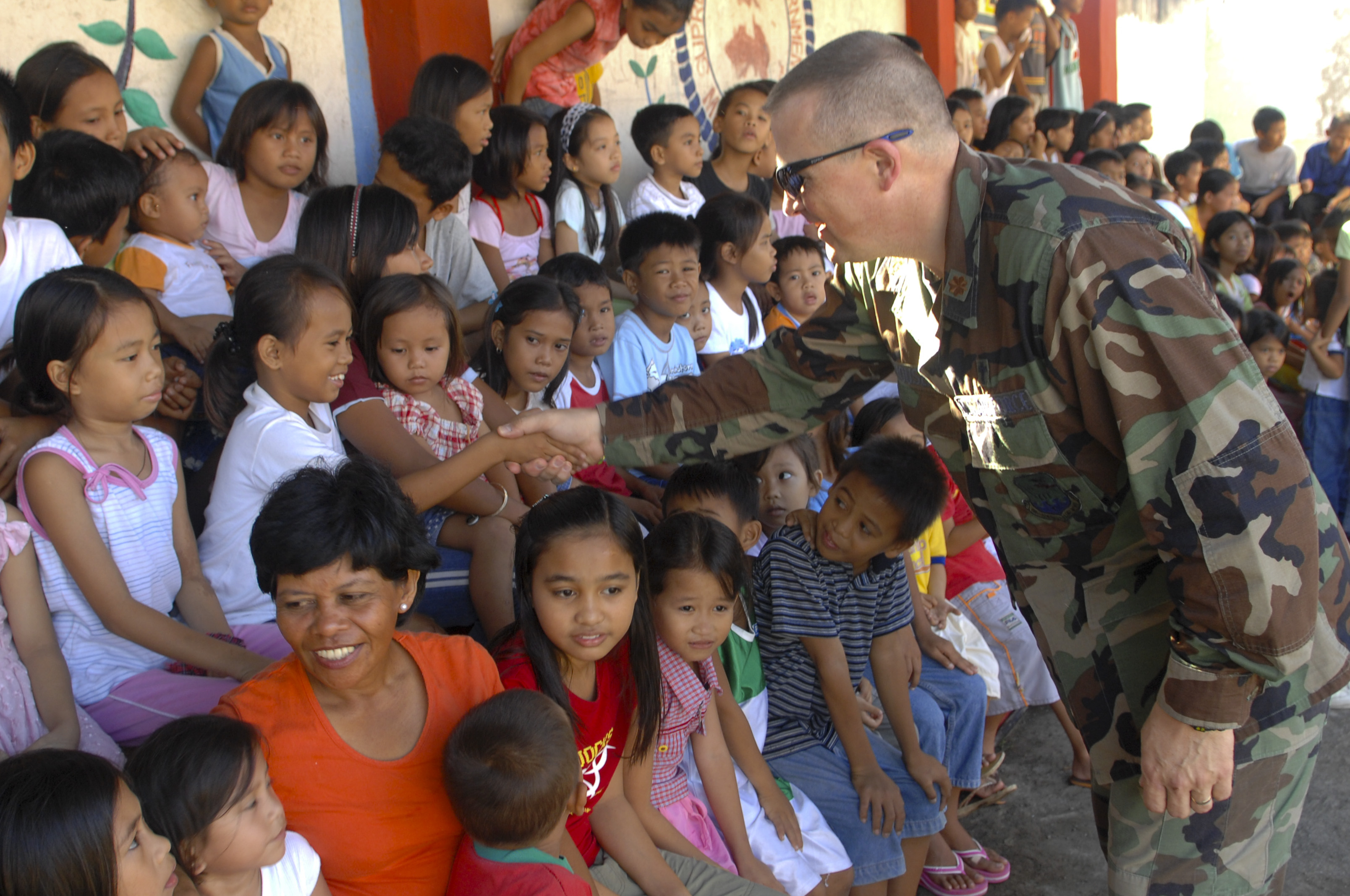 US Navy 071215-N-7286M-010 U.S. Air Force Chaplain, Maj. Philip G. Houser meets with the children at MEIN College