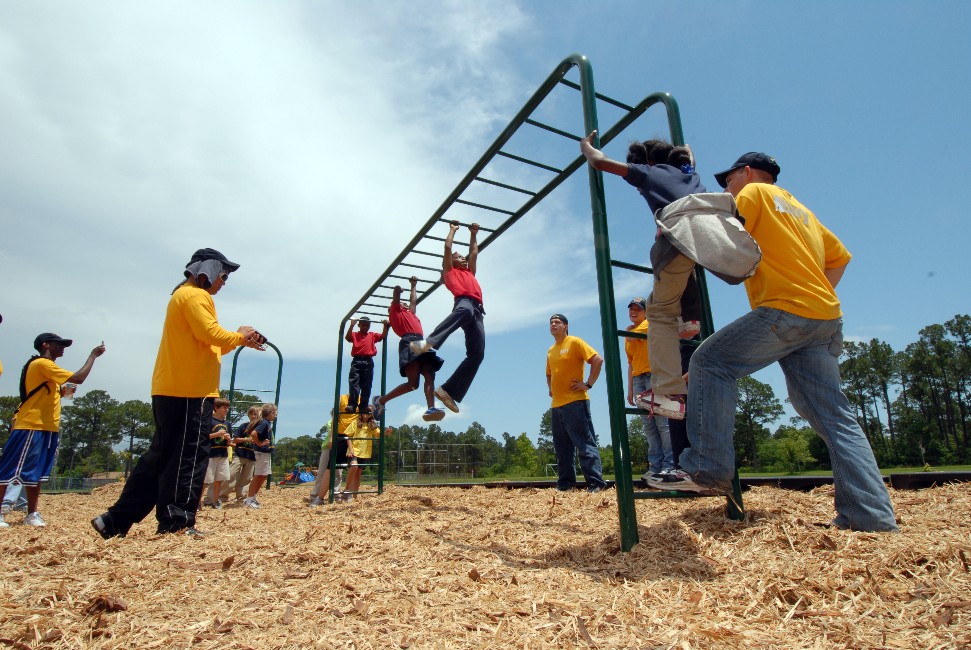 US Navy 090515-N-2565P-222 Sailors assigned to Pre-Commissioning Unit (PCU) Makin Island (LHD 8) watch students at College Park Elementary play on a $35,000 calisthenics playground