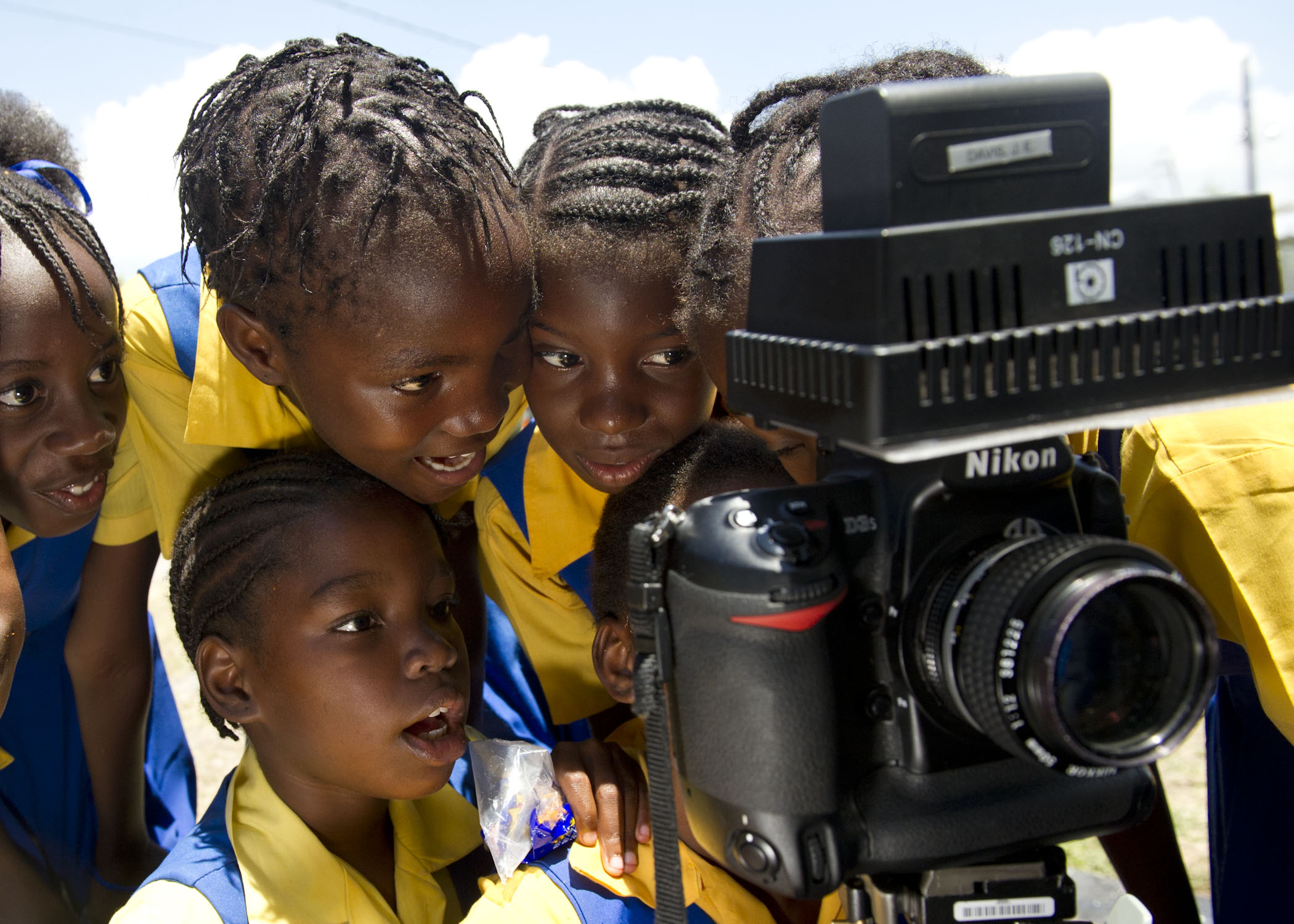 US Navy 110419-N-RM525-454 School children watch a video recording of themselves singing during a Continuing Promise 2011 community service project