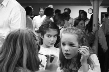 Young girl applying cosmetics.
