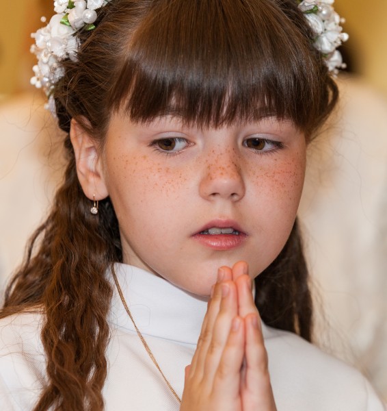 a Catholic child girl on her first Holy Communion Mass in June 2014, picture 2/4