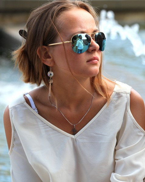 a Catholic girl wearing sunglasses, photographed in Milan, Italy, in August 2013