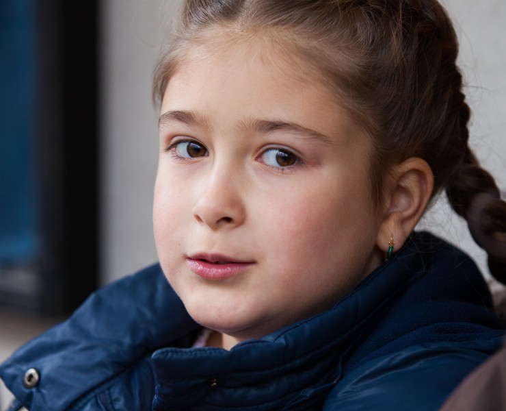 a cute child girl photographed near a Catholic chapel in November 2013, picture 2/2