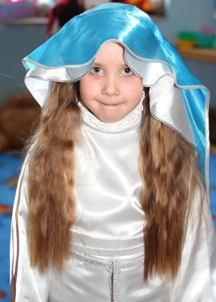 a girl playing the role of the Virgin Mary in the Nativity scene