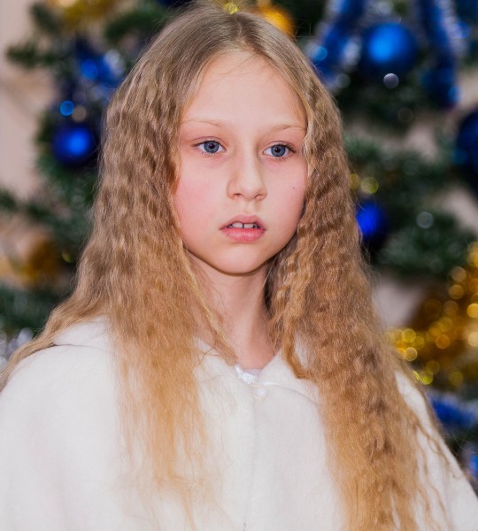 a young blond pretty schoolgirl photographed in December 2013, picture 1/6