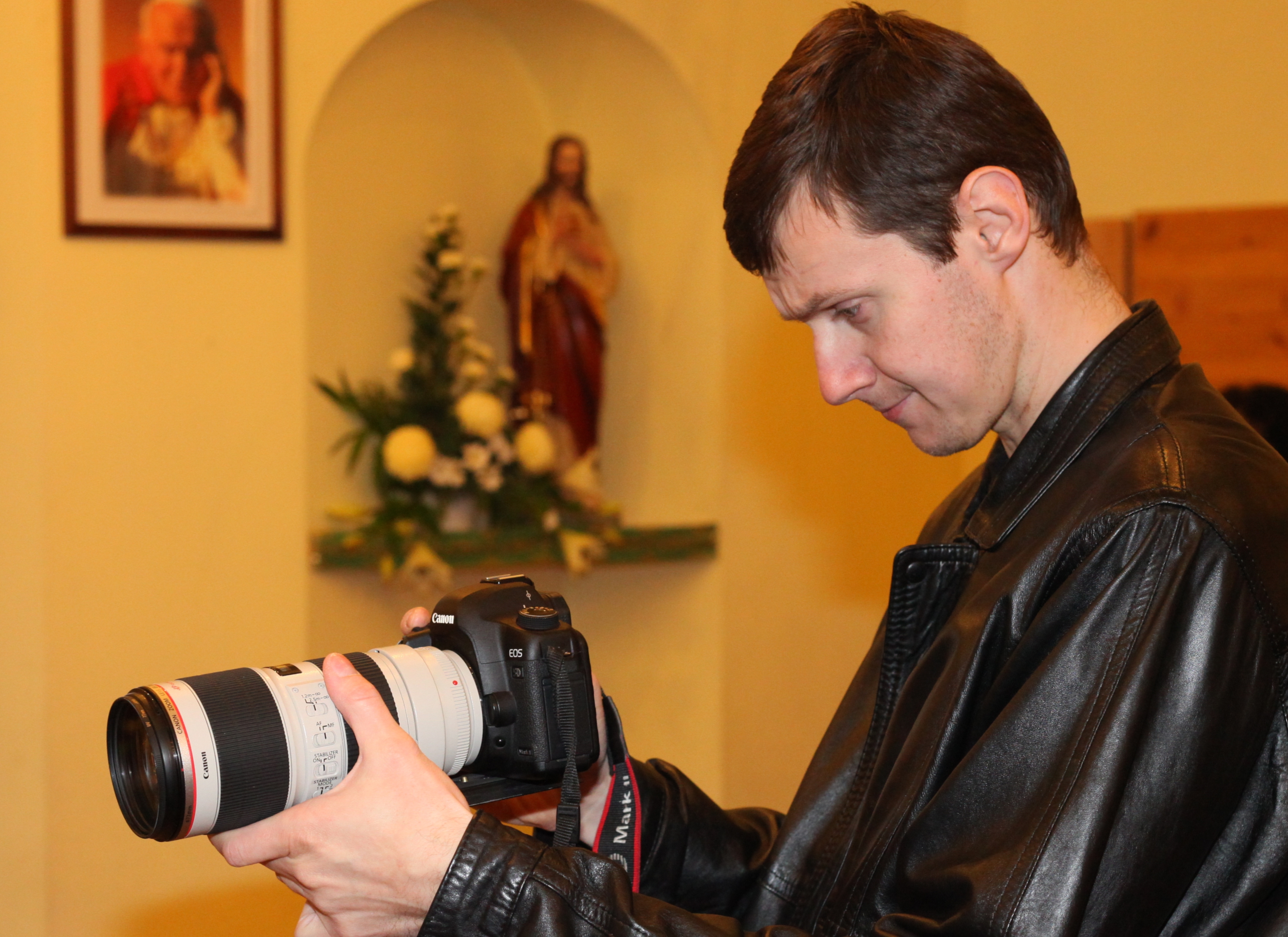 a man taking video in a Church with a Canon EOS 5D Mark II camera