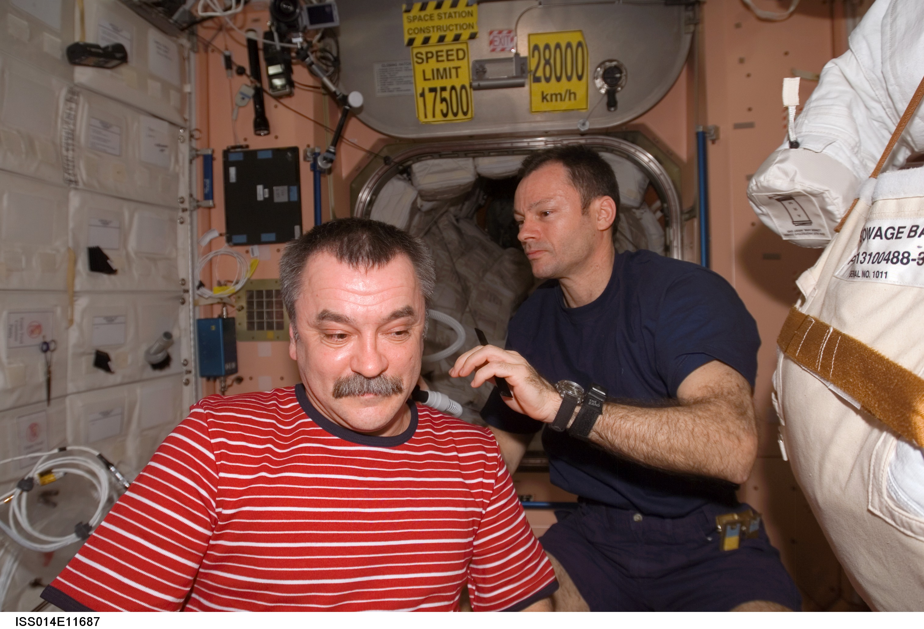 Cosmonaut Mikhail Tyurin getting a haircut in space