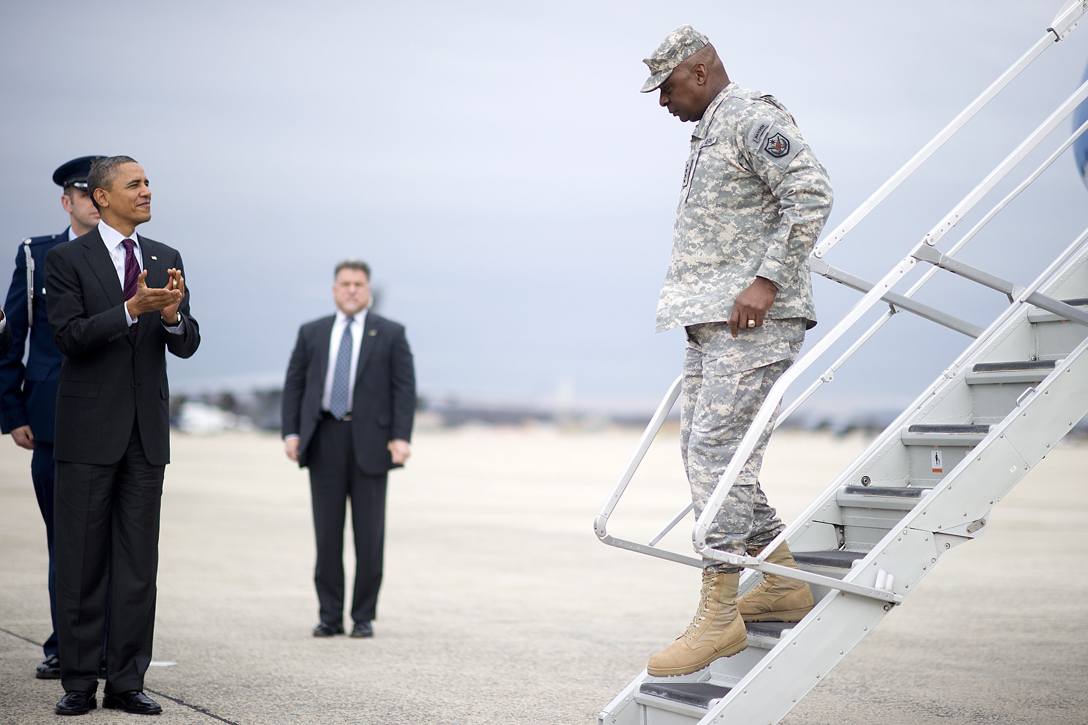 President Barack Obama, left, applauds U.S. Army Gen. Lloyd J. Austin III, the final commander of U.S. Forces Iraq, as he arrives at Joint Base Andrews, Md., Dec. 20, 2011