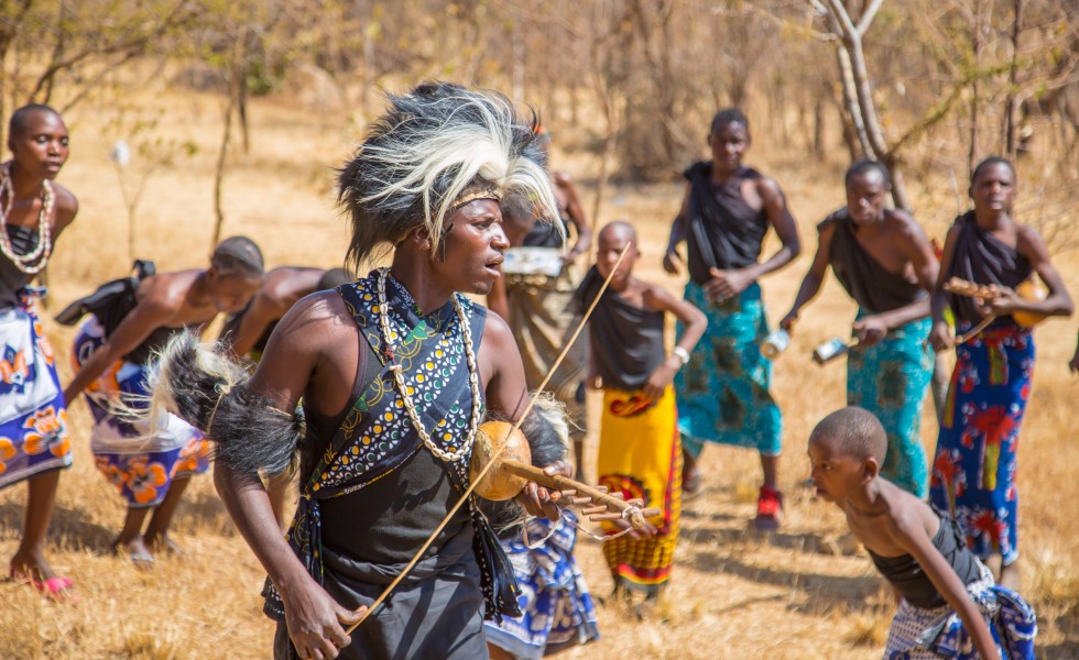 A Man from Gogo Tribe singing while palying Zeze with his tribe mate, Zeze is one of the famous Musical Instrumental In Tanzania