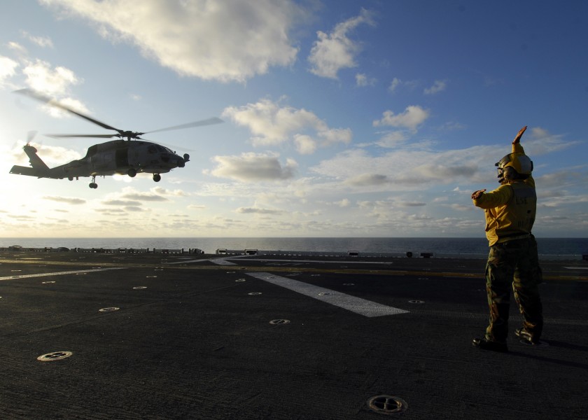US Navy 080830-N-4236E-021 Aviation Boatswain's Mate Handling 3rd Class Charniah Yearwood signals an MH-60S Sea Hawk