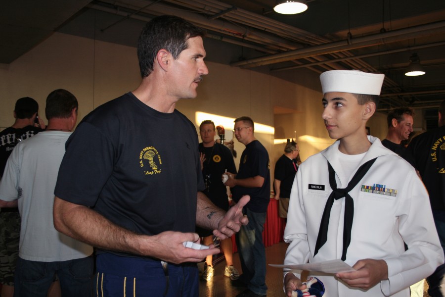 US Navy 090702-N-5366K-333 Chief Special Warfare Operator (SEAL) William Davis, assigned to the U.S. Navy Parachute Team the Leap Frogs, talks to a U.S. Navy Sea Cadet Corps cadet from the Seal Beach Battalion