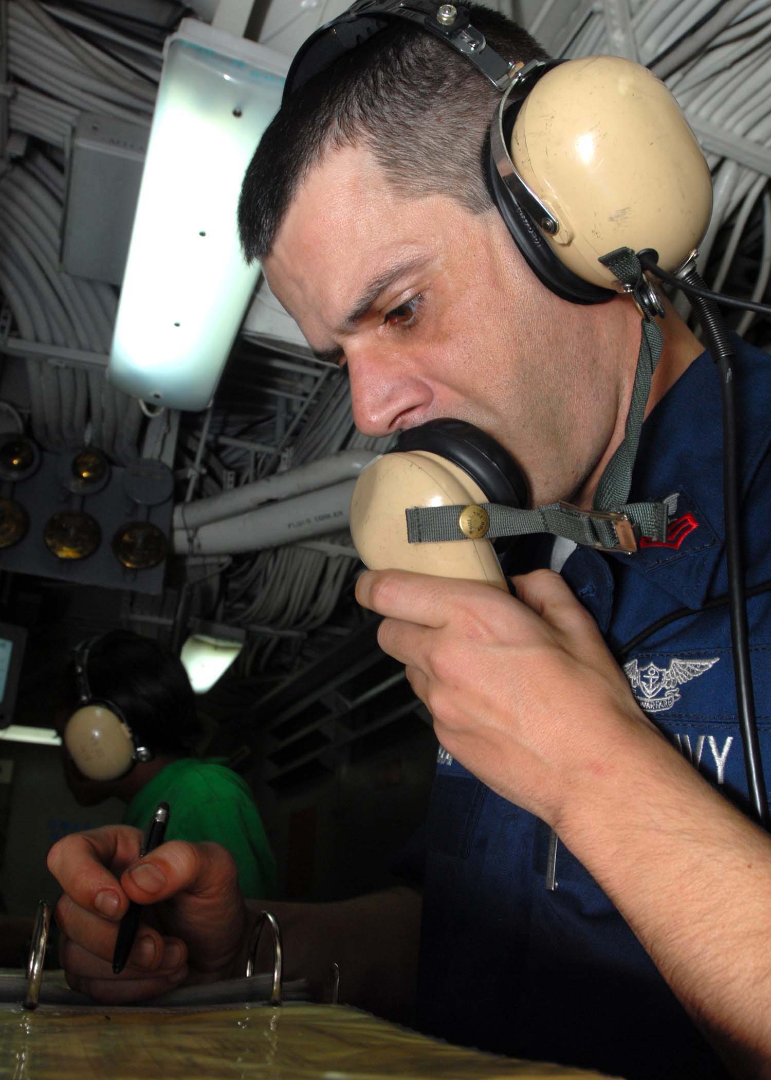 US Navy 081130-N-2456S-073 Aviation Boatswain's Mate (Equipment) 1st Class Tony Pavao ensures all personnel are manned on station