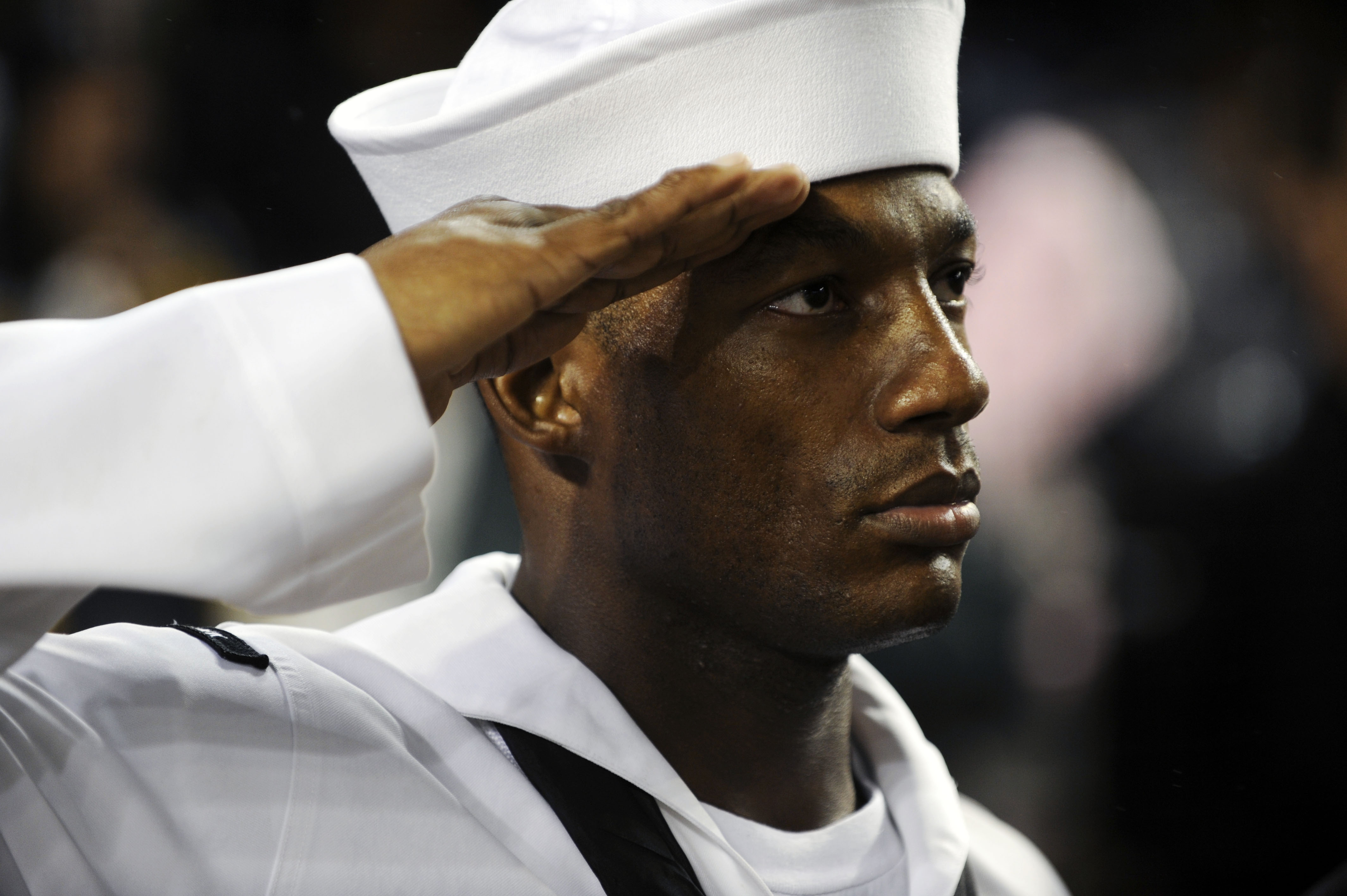 US Navy 090911-N-0413R-227 Chief Information Systems Technician Hakim Bristow salutes during the national anthem during a pre-game ceremony at Yankee Stadium