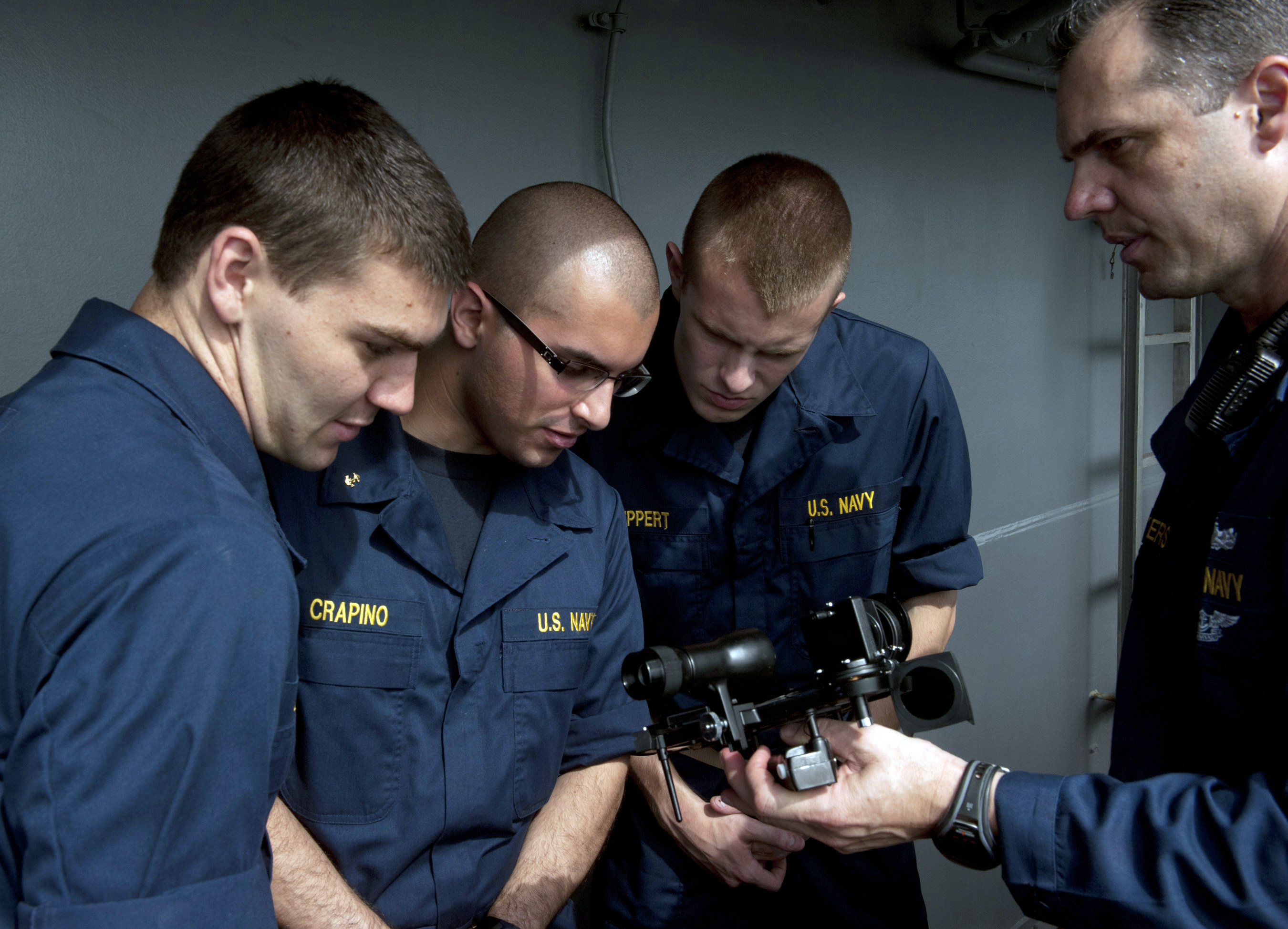 US Navy 110528-N-DR144-901 Master Chief Quartermaster Jonathan Myers teaches midshipmen how to use a sextant for celestial navigation