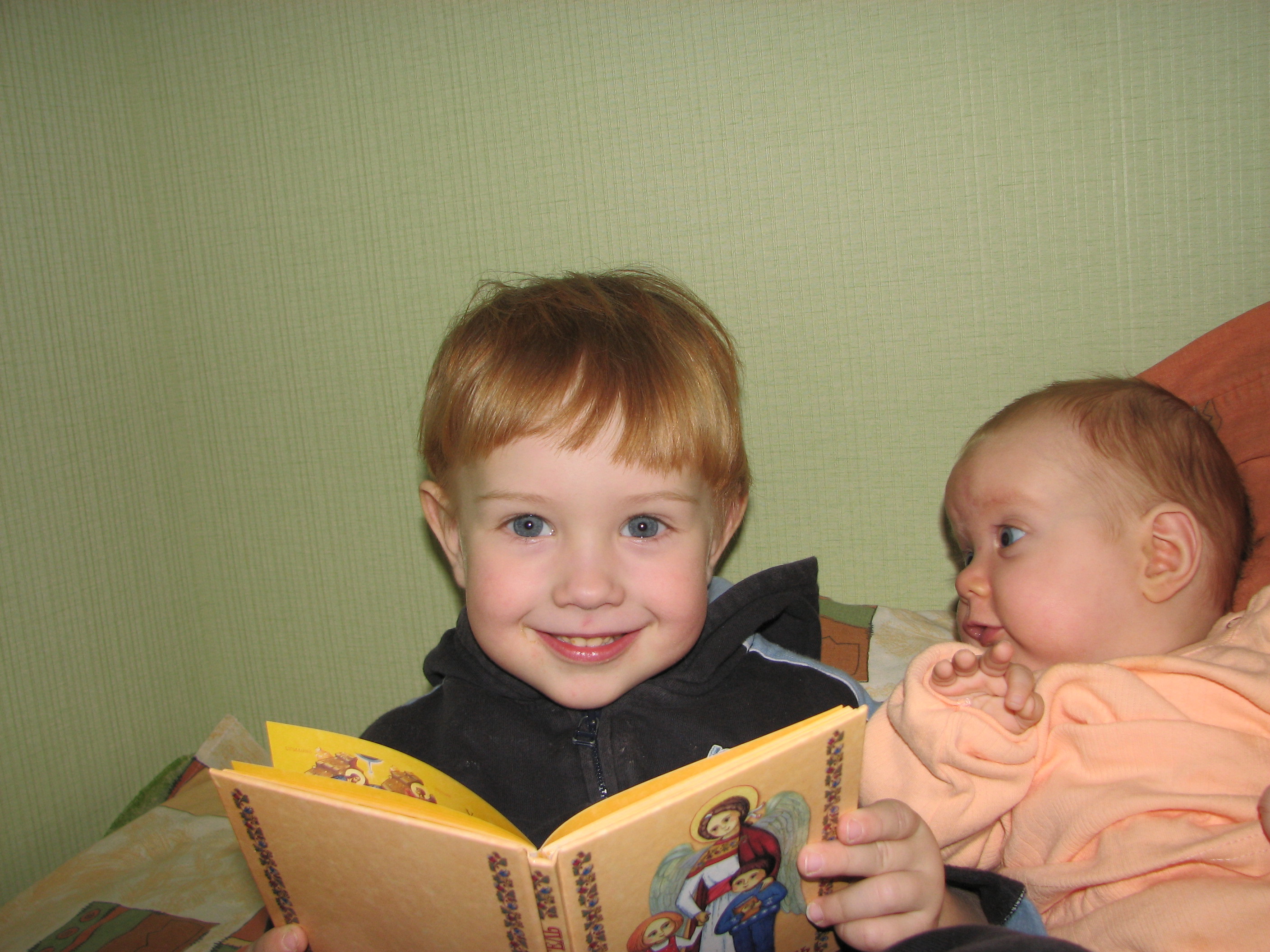 Funny look of a baby sister at her small brother