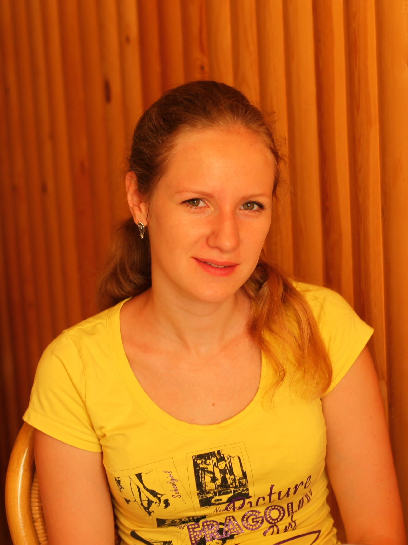 A beautiful blond girl in a yellow t-shirt