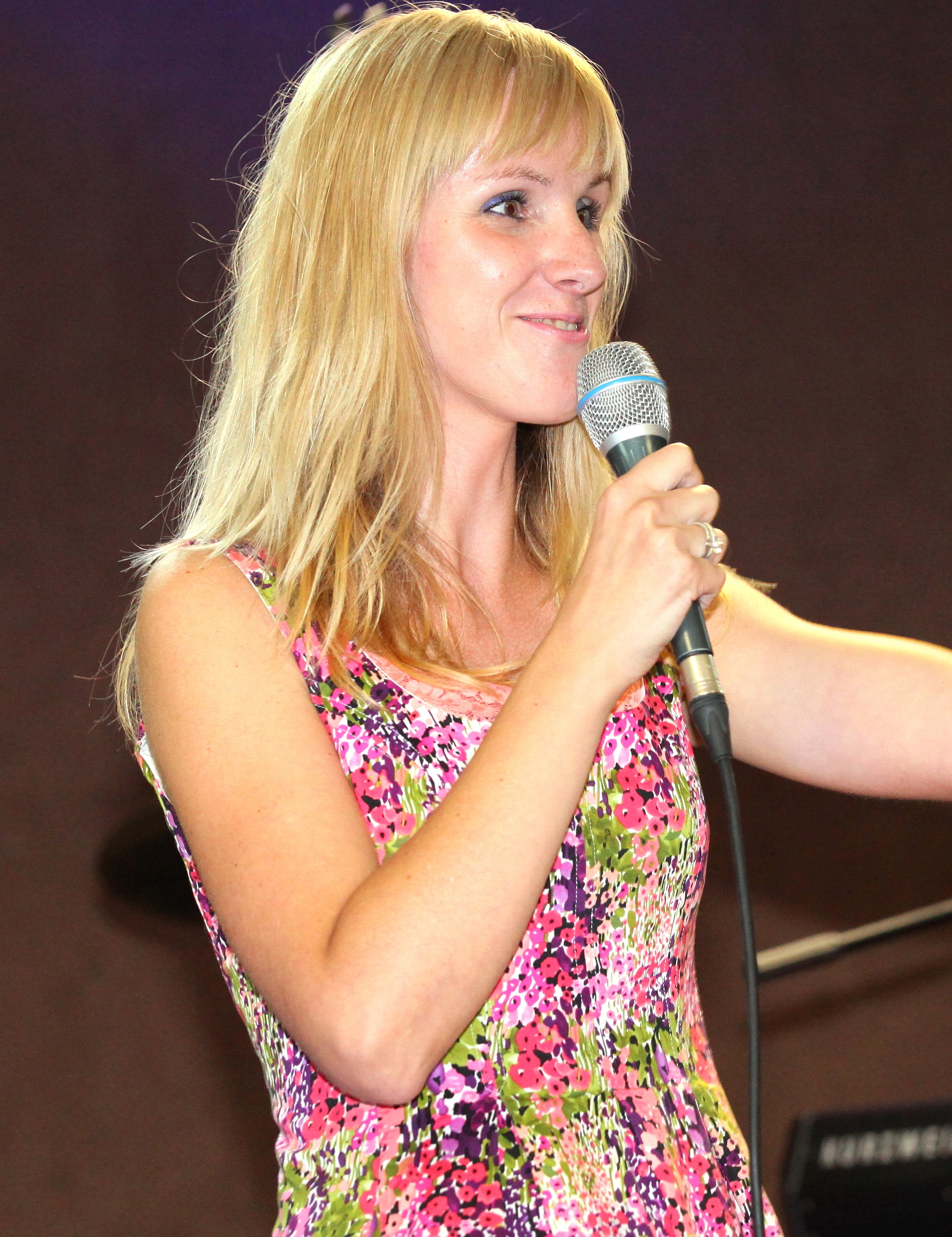 a blond girl at a stage at a protestant gathering in July 2013, image 2/7