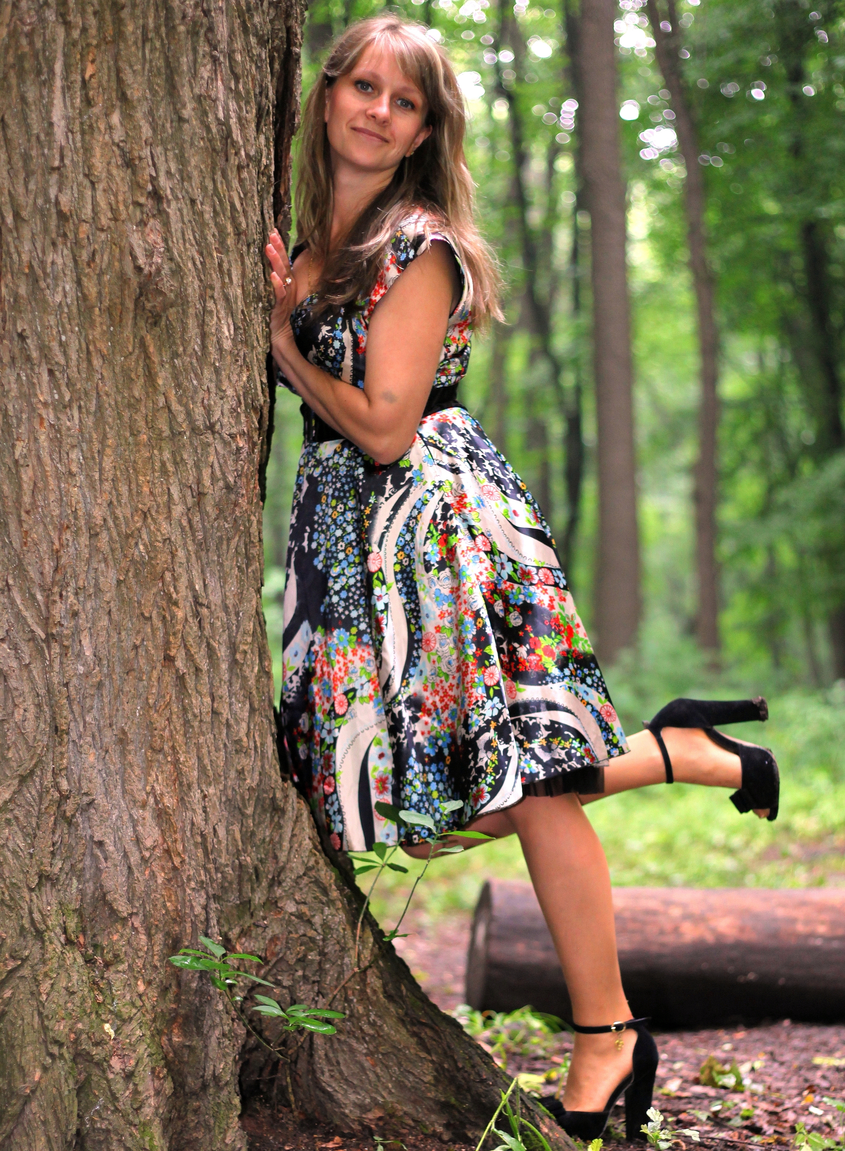 a young Catholic woman wearing a colorful dress in a forest in June 2013, portrait 1/9