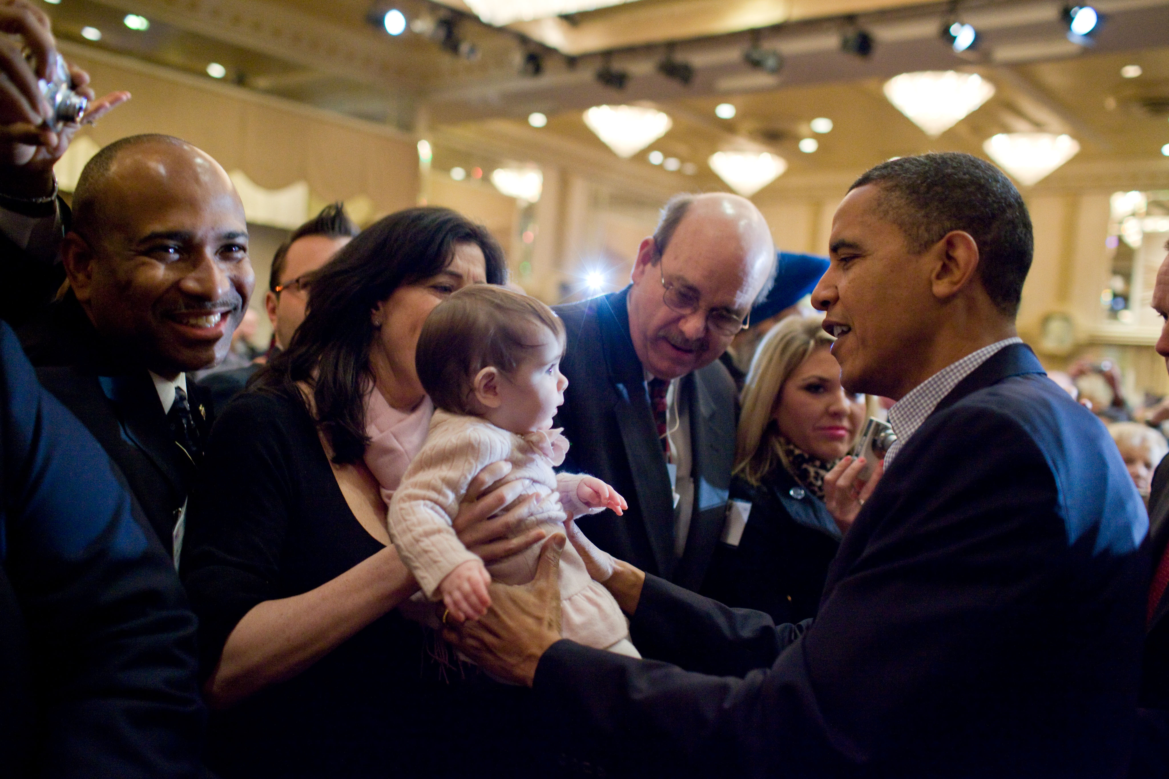 Barack Obama holds a child of a supporter, 2010