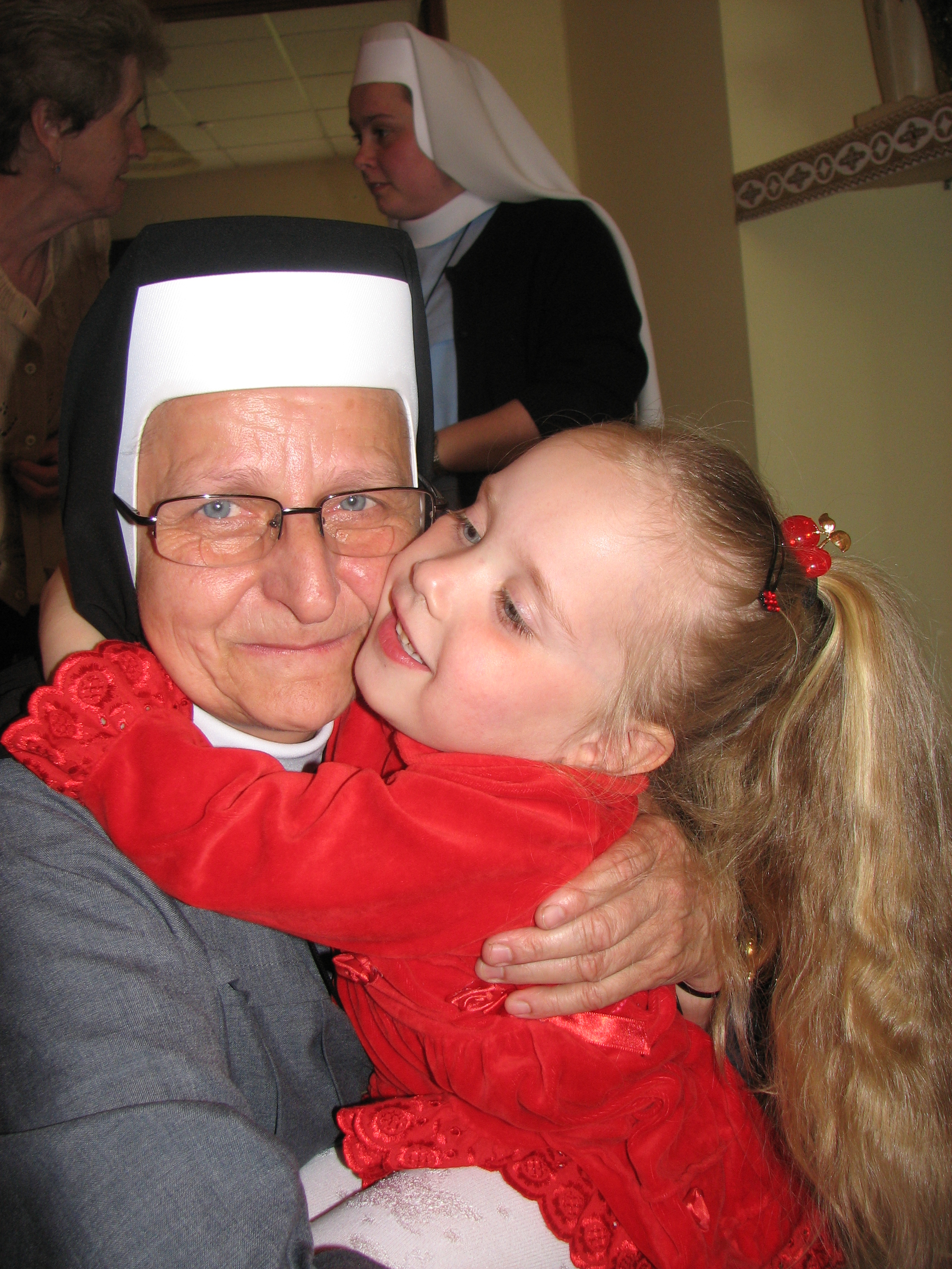 A Catholic nun with a small Catholic child girl