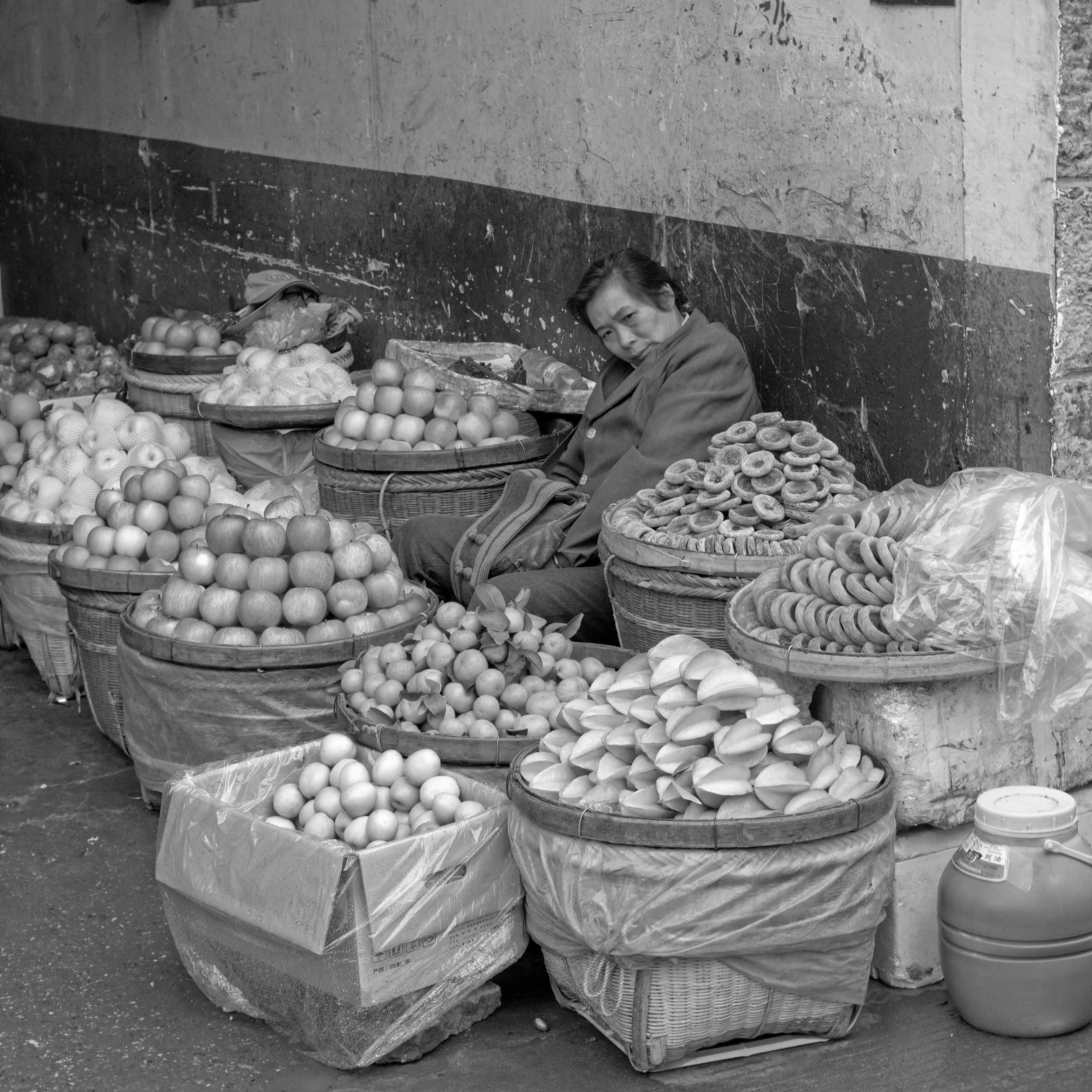 Chinese Woman selling fruits in the street