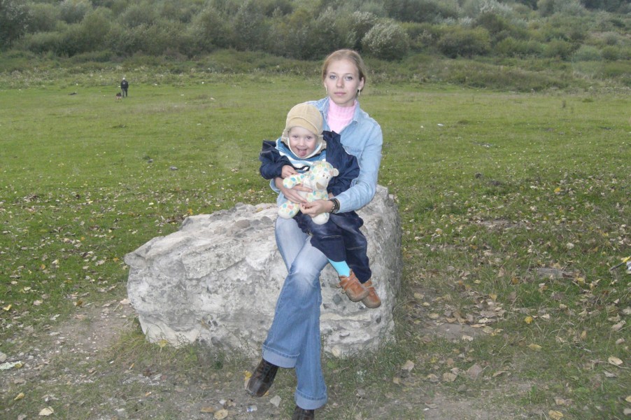 A young blond woman with a small boy on her lap