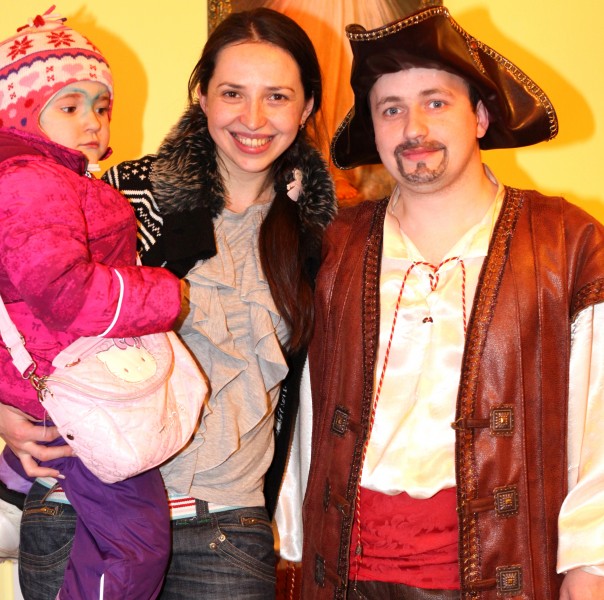 a beautiful brunette Catholic woman with her cute daughter and a man in a Catholic kindergarten, photo 1