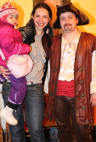 a beautiful brunette Catholic woman with her cute daughter and a man in a Catholic kindergarten, photo 2