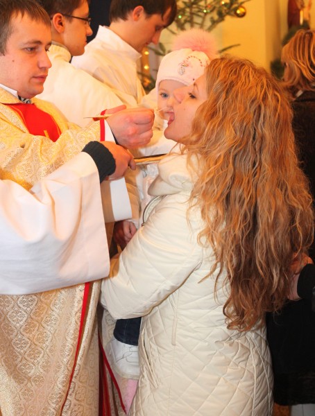  young beautiful blond woman taking Jesus in the Holy Communion