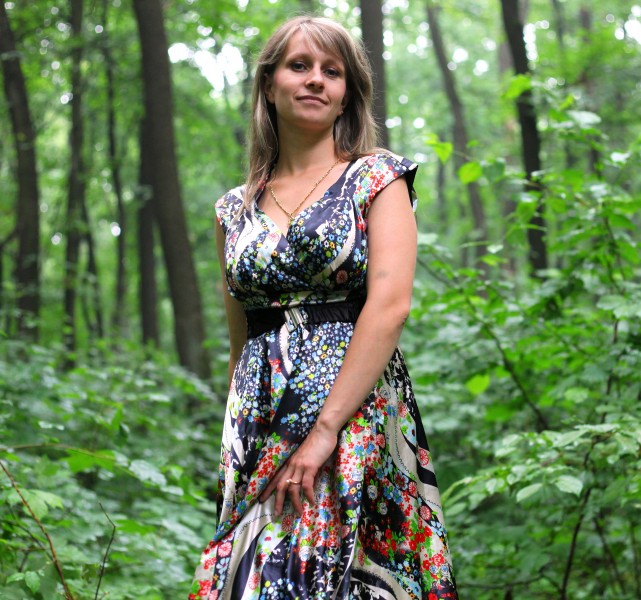 a young Catholic woman wearing a colorful dress in a forest in June 2013, portrait 8/9