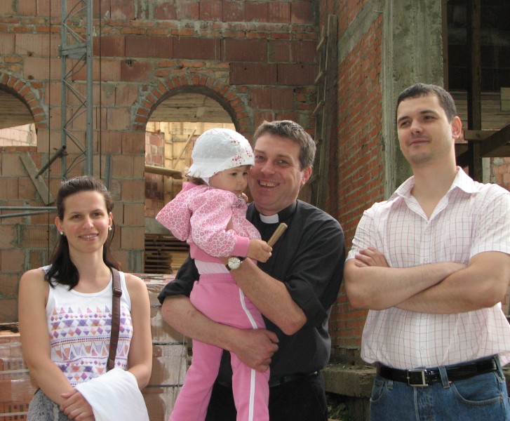 A Catholic priest (in the middle) with a young family, pic 3
