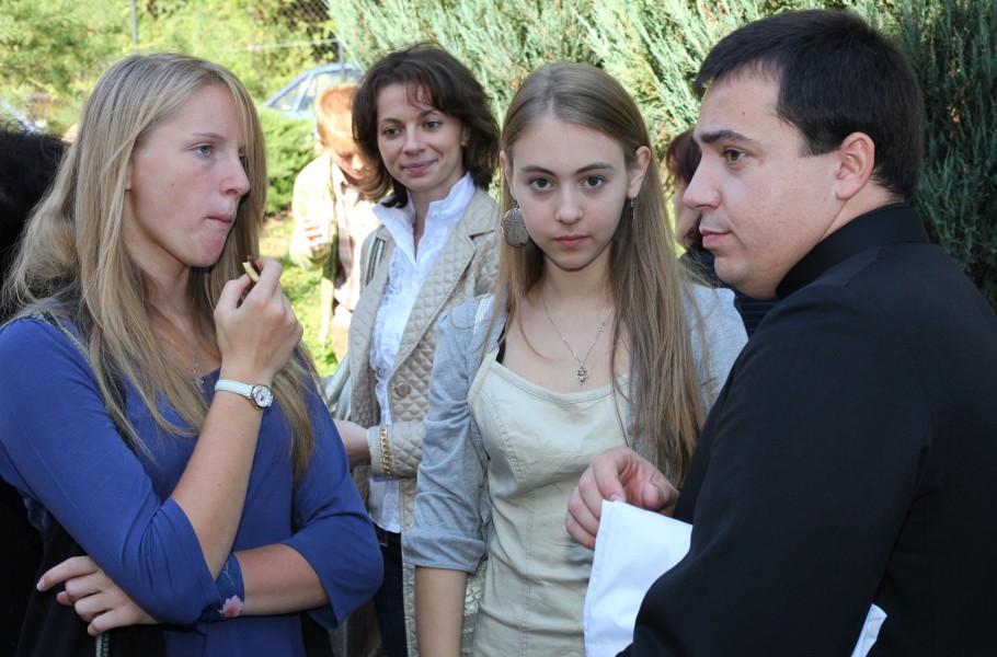 girls and a priest near a Catholic Church after the Holy Mass, photo 2