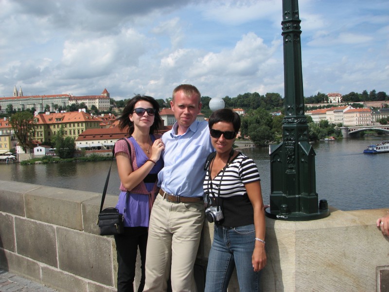 A young man with two girls near Vltava river in Prague (Praha) city, Czech Republic, European Union