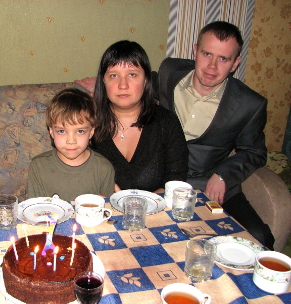 Miscellaneous people at a table: son, mother and godfather.